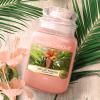 Large pink candle in a glass jar 